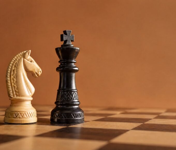 A photographic chessboard showing a white knight near a black king in warm natural light, with an African design sensibility, an uncluttered plain.